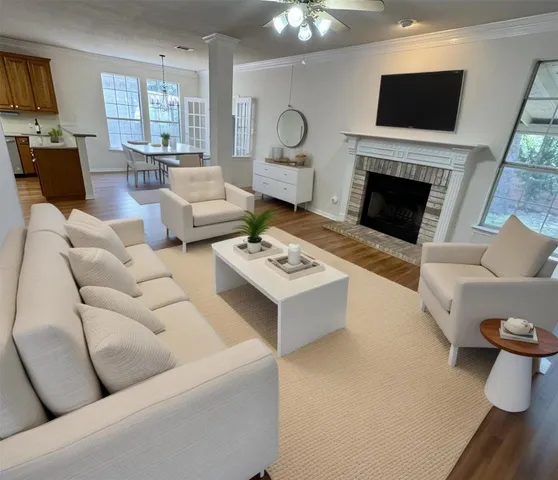 a living room with furniture a flat screen tv and a fireplace