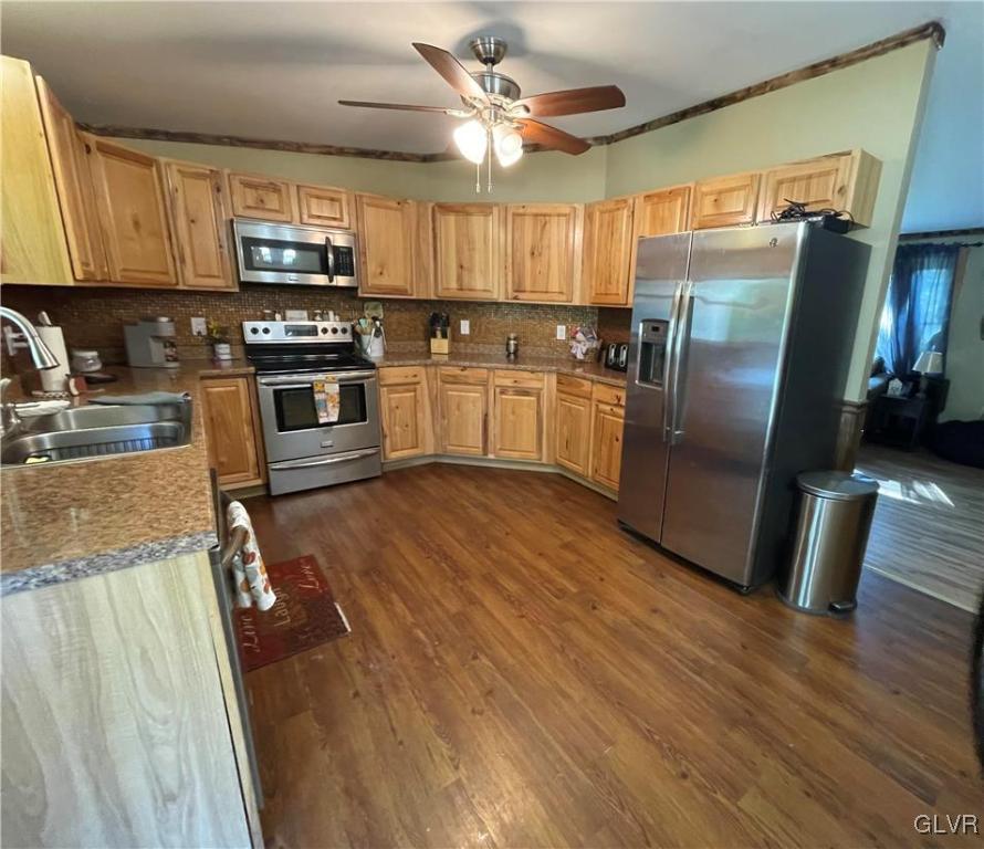 147 Tilly Lane Effort, PA 18330 - Photo 19 of 48 a kitchen with granite countertop a refrigerator a stove a sink and white cabinets with wooden floor