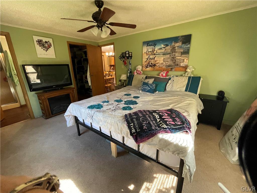 147 Tilly Lane Effort, PA 18330 - Photo 29 of 48 a bedroom with a bed and a flat tv screen on dresser