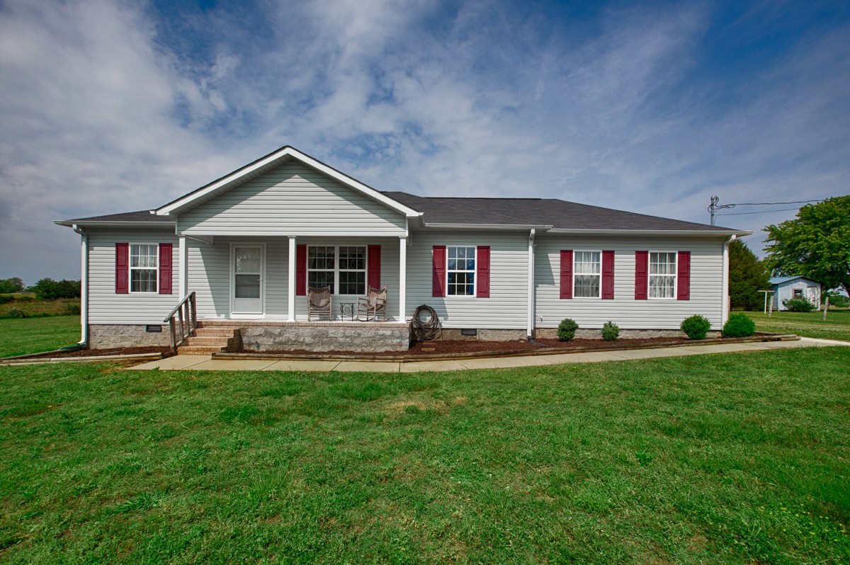 253 Old Baptist Road Ardmore, TN 38449 - Photo 1 of 23 a front view of a house with a yard and patio