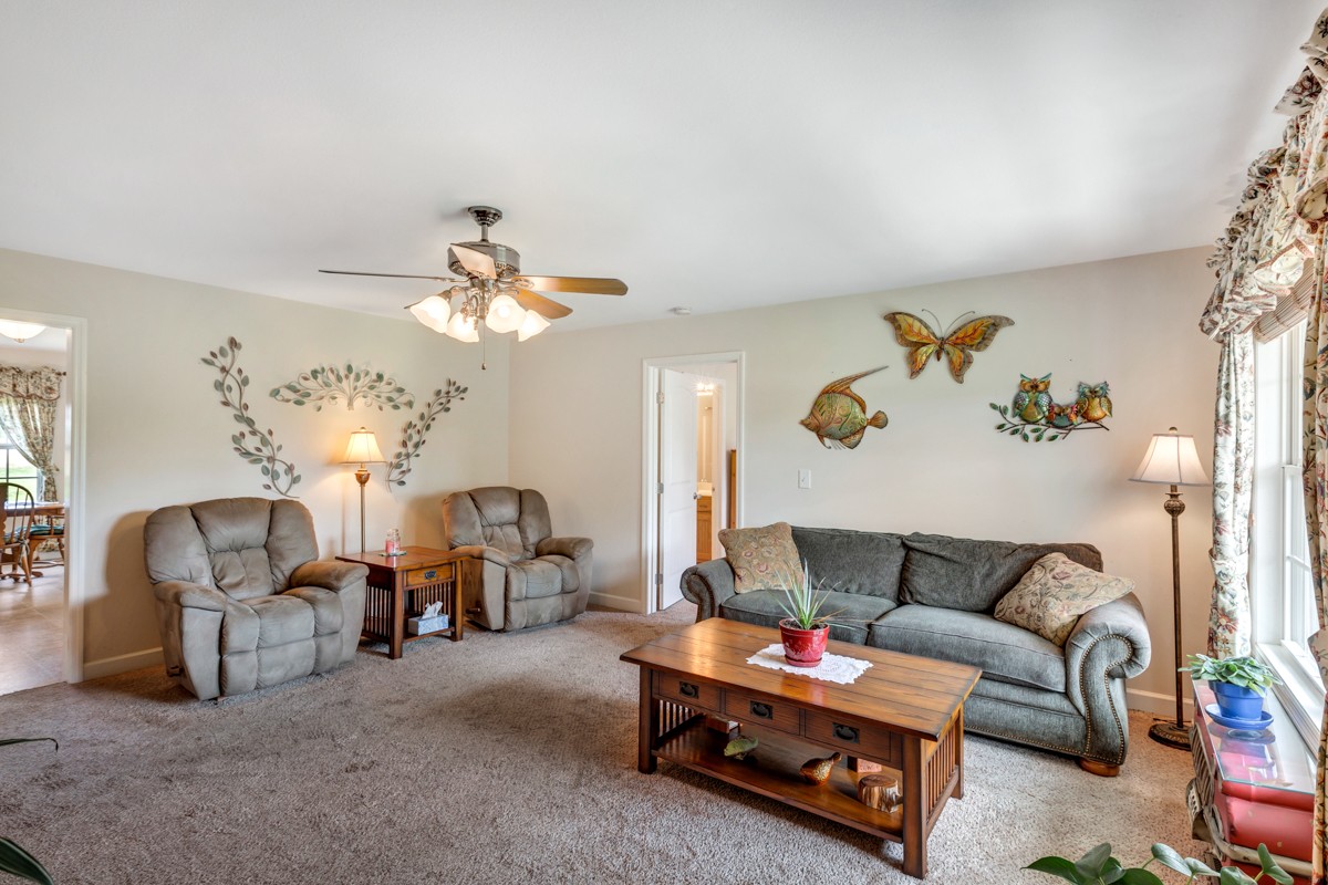253 Old Baptist Road Ardmore, TN 38449 - Photo 11 of 23 a living room with furniture and a chandelier