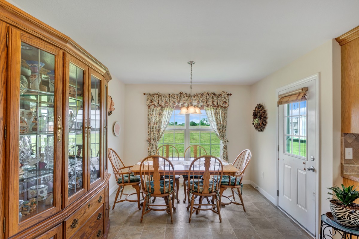 253 Old Baptist Road Ardmore, TN 38449 - Photo 13 of 23 a dining room with furniture a chandelier and wooden floor