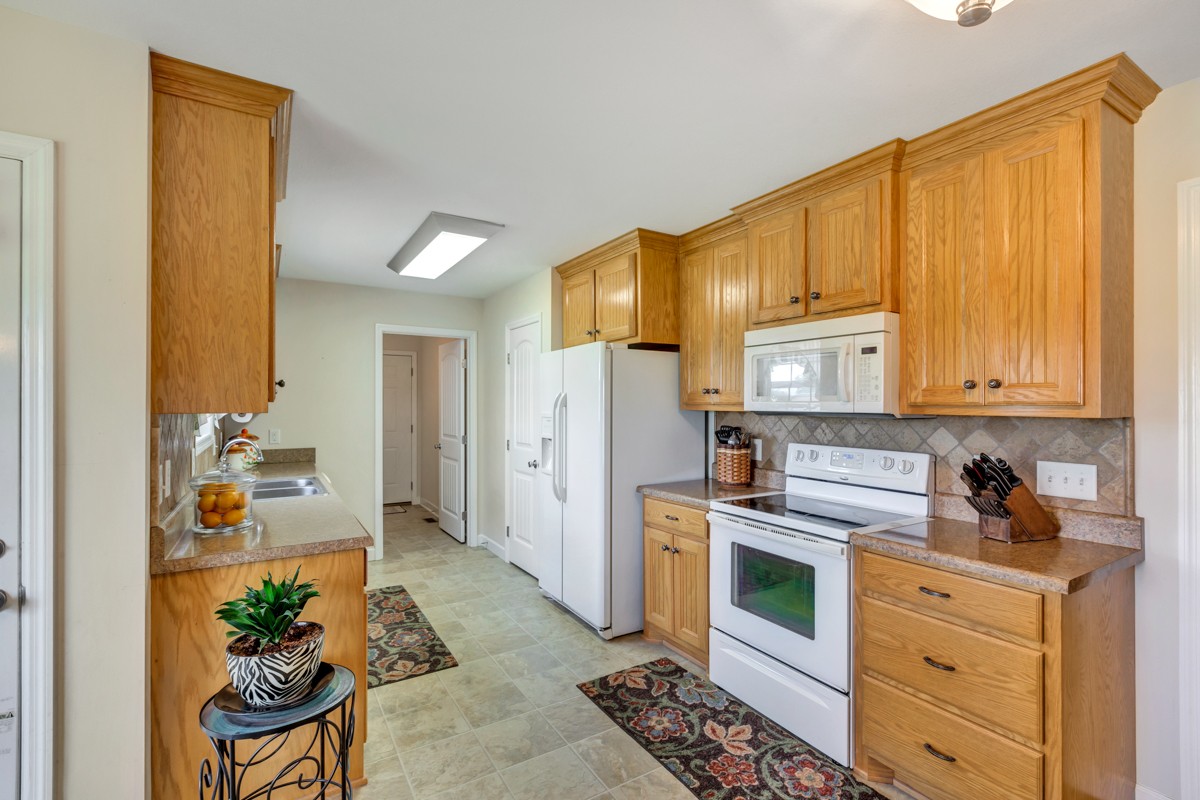 253 Old Baptist Road Ardmore, TN 38449 - Photo 15 of 23 a kitchen with a refrigerator and cabinets