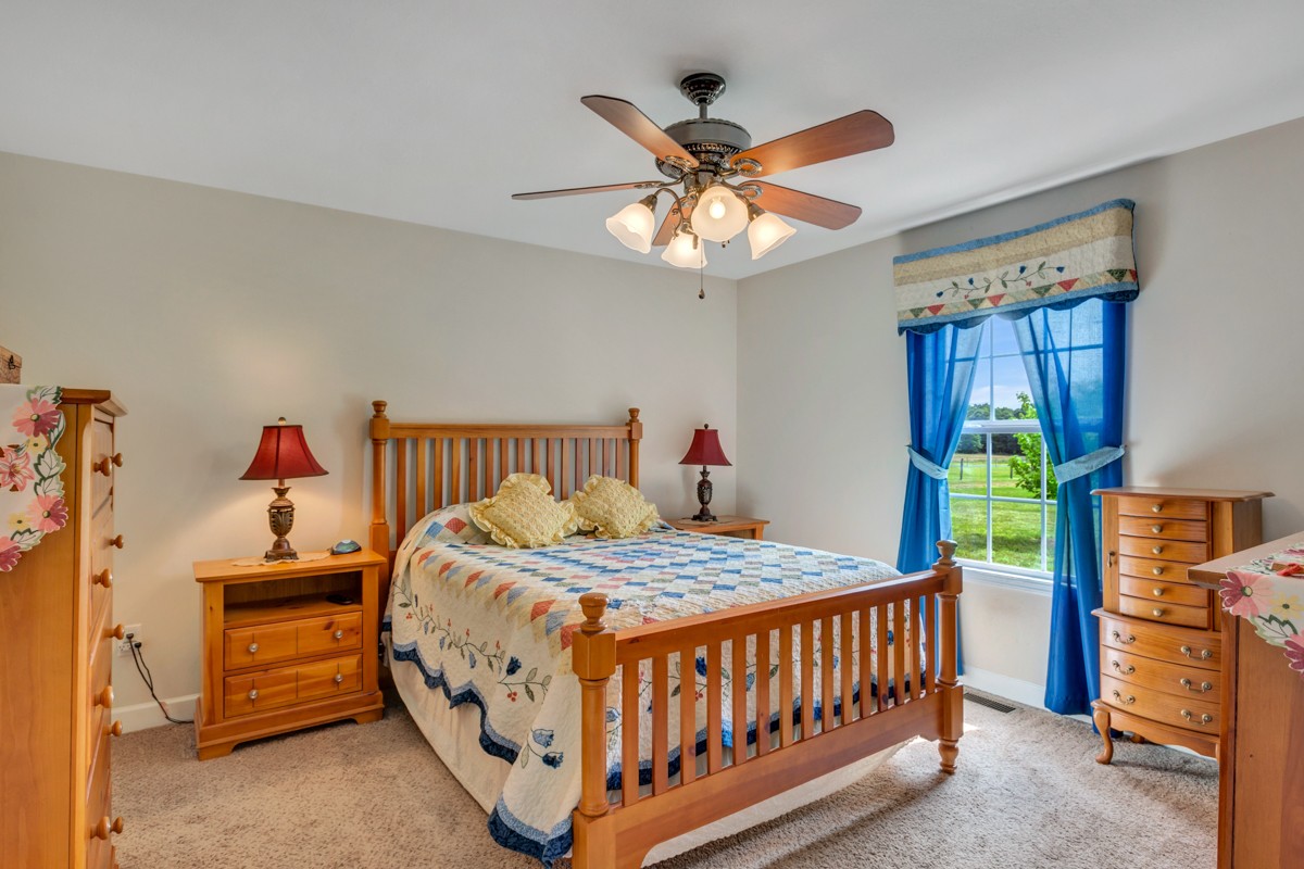253 Old Baptist Road Ardmore, TN 38449 - Photo 18 of 23 a bedroom with a bed and a chandelier