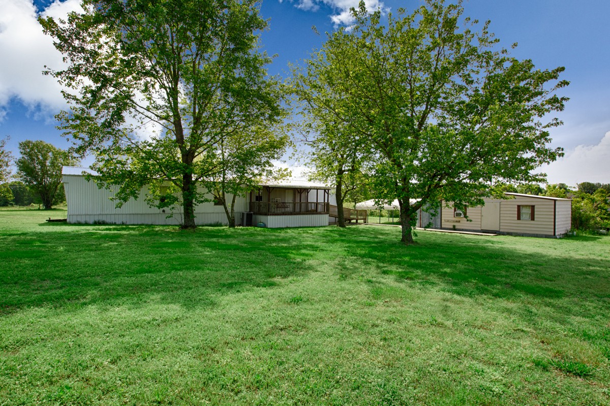 253 Old Baptist Road Ardmore, TN 38449 - Photo 7 of 23 a front view of a house with a garden