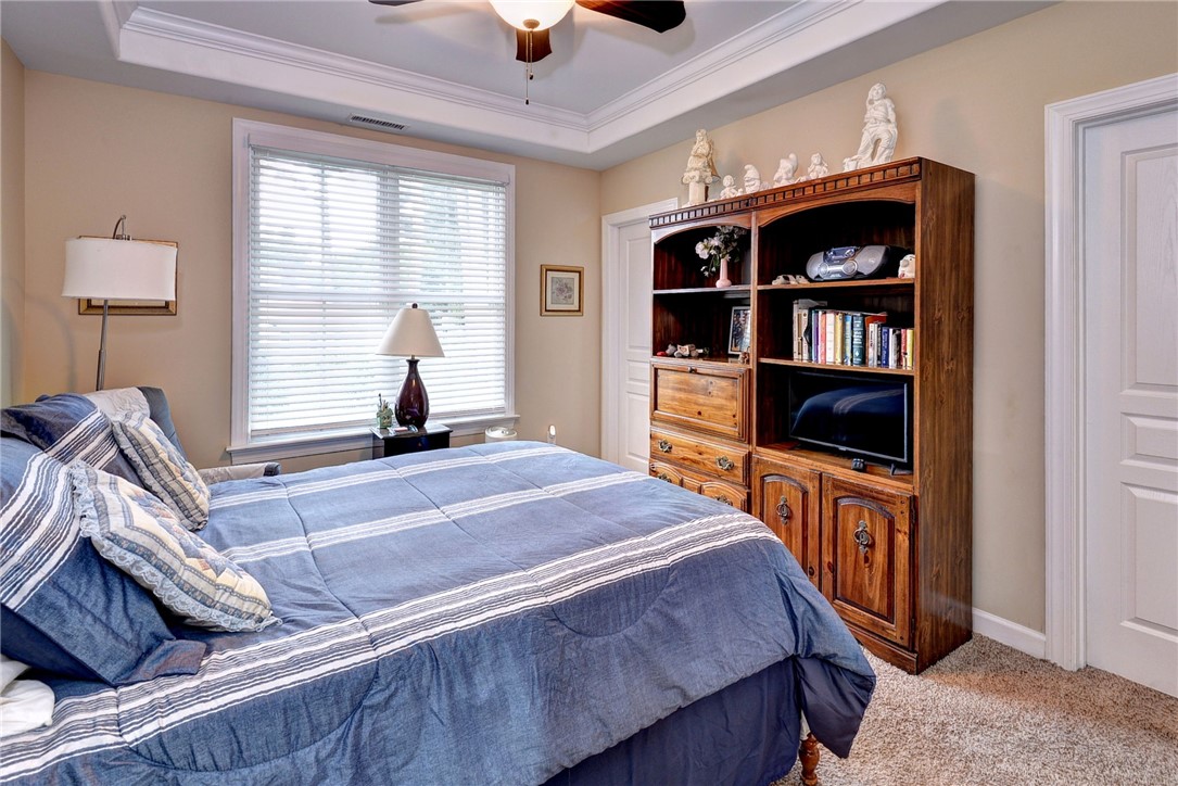 11 Butler Farm Road Hampton, VA 23666 - Photo 31 of 39 Bedroom featuring carpet flooring, crown molding, a tray ceiling, and ceiling fan