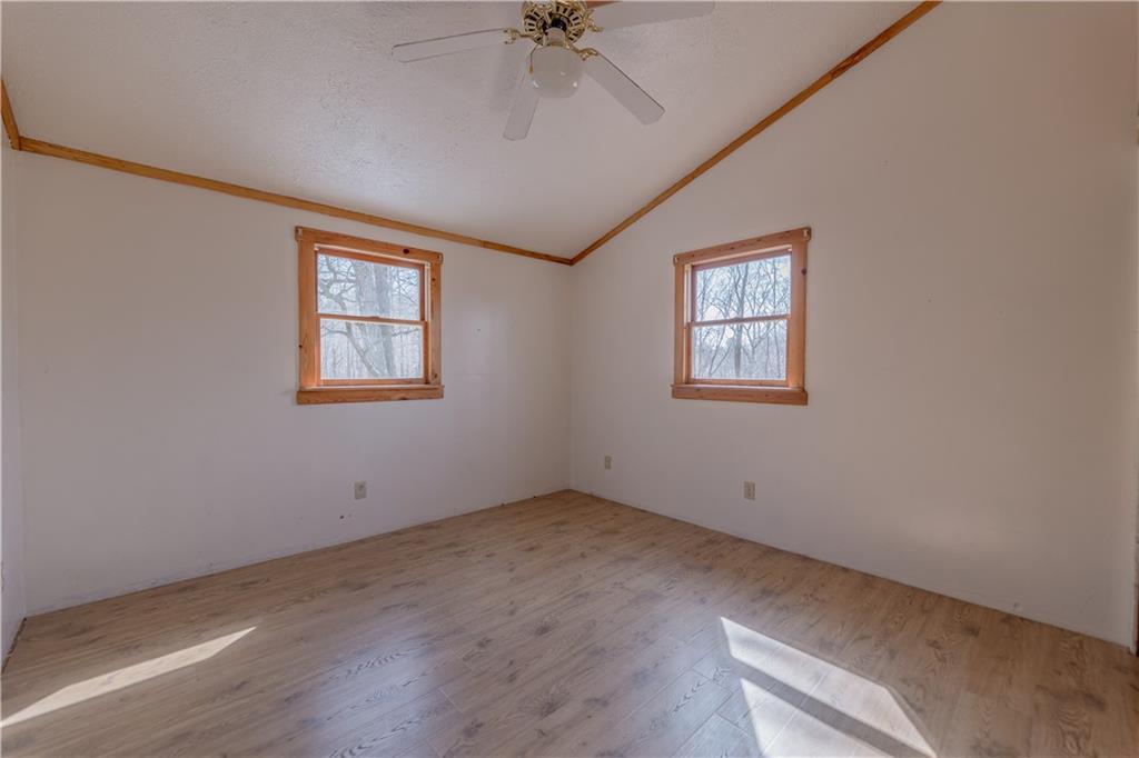 185 Turk Road Slippery Rock, PA 16057 - Photo 21 of 24 an empty room with a chandelier fan and windows