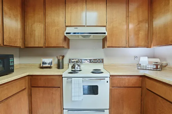 a kitchen with a sink a stove and cabinets