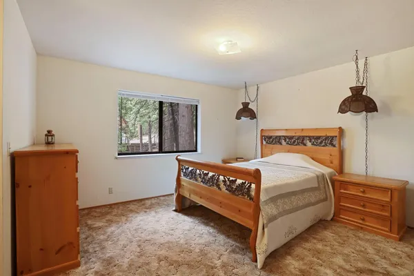 a bed sitting in a bedroom next to a window