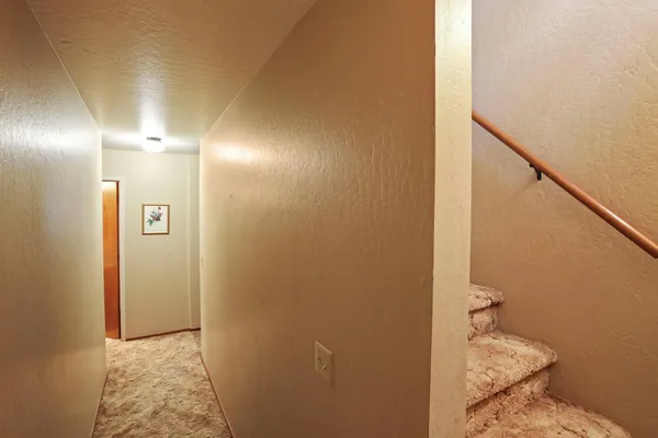 a bathroom with a granite countertop sink and a toilet