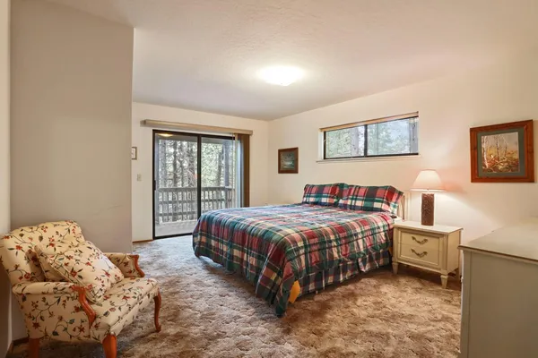 a bedroom with a bed next to a window