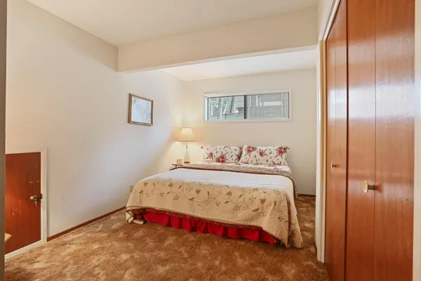 a bedroom with a bed and a table