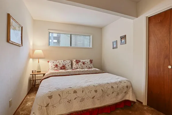 a bedroom with a bed and a night stand