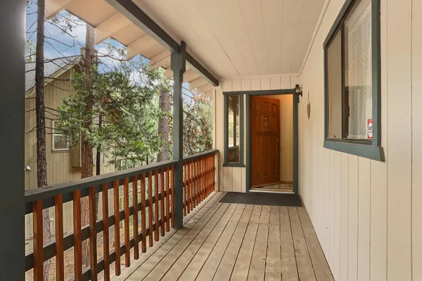 a view of a balcony with wooden floor