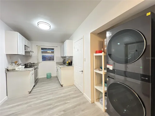 a view of a kitchen with a sink microwave and cabinets