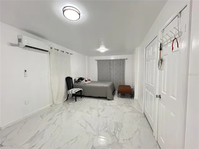 a bed room with a bed and a chair