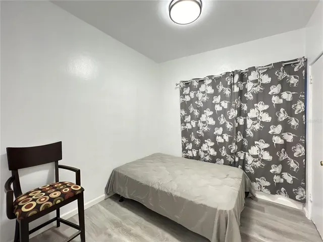 a bedroom with a bed and a chair