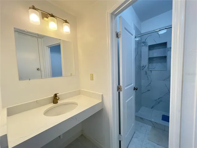 a bathroom with a sink and a mirror