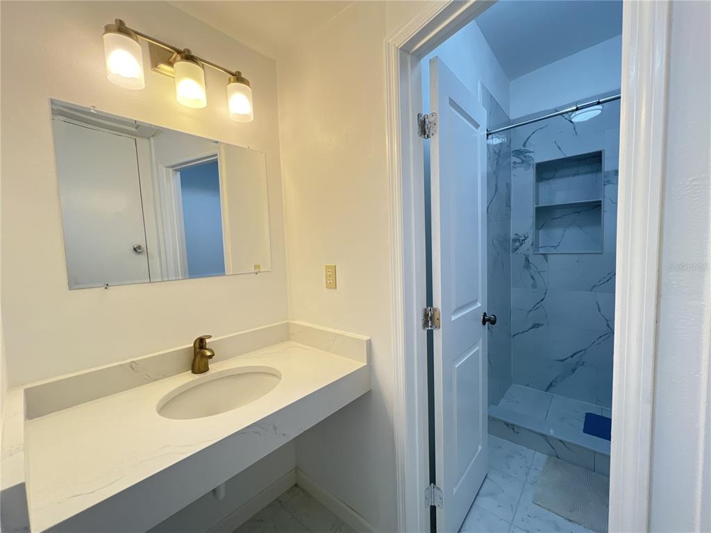 902 San Domingo Road Orlando, FL 32808 - Photo 17 of 18 a bathroom with a sink and a mirror