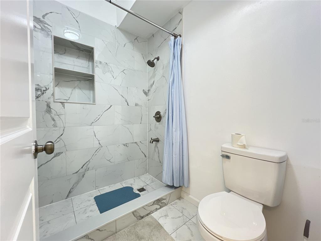 902 San Domingo Road Orlando, FL 32808 - Photo 18 of 18 a white toilet sitting next to a bathroom