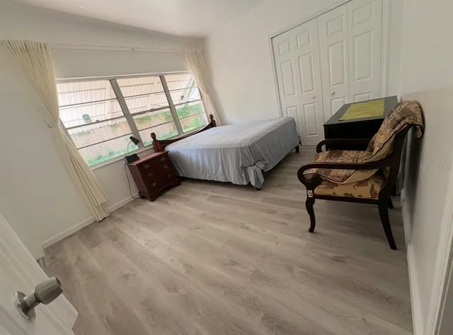 a bedroom with a bed and a window