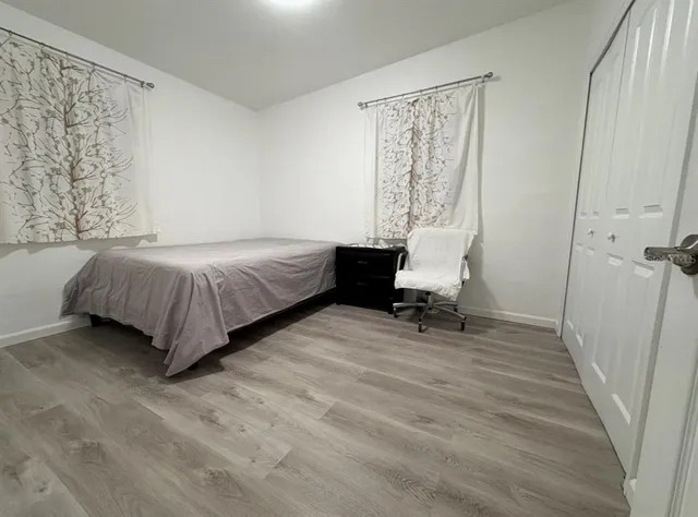 a living room with a bed furniture and a window