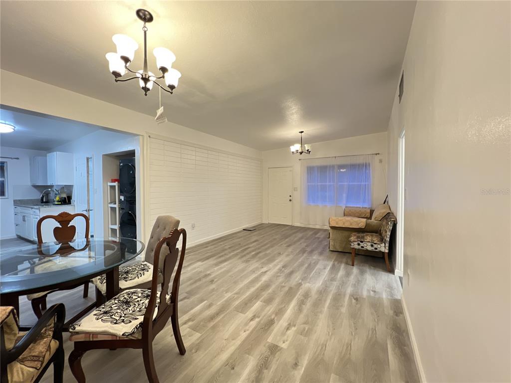 902 San Domingo Road Orlando, FL 32808 - Photo 5 of 18 a view of a dining room with furniture and wooden floor