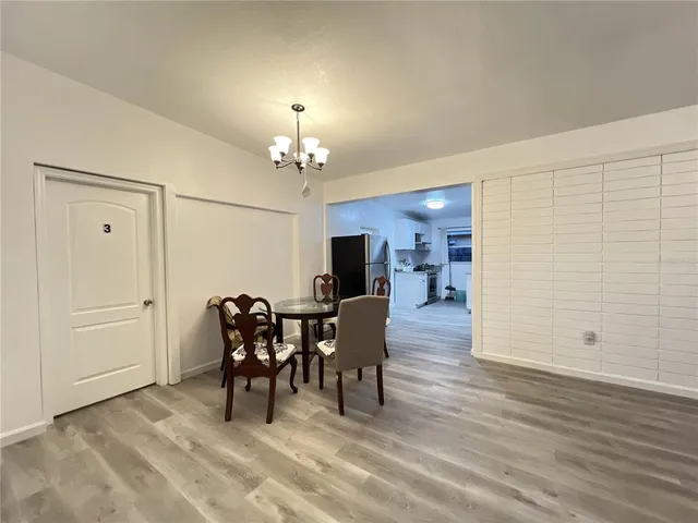 a view of a dining room with furniture and chandelier