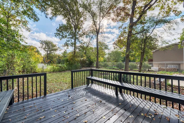 a view of balcony with wooden floor and fence