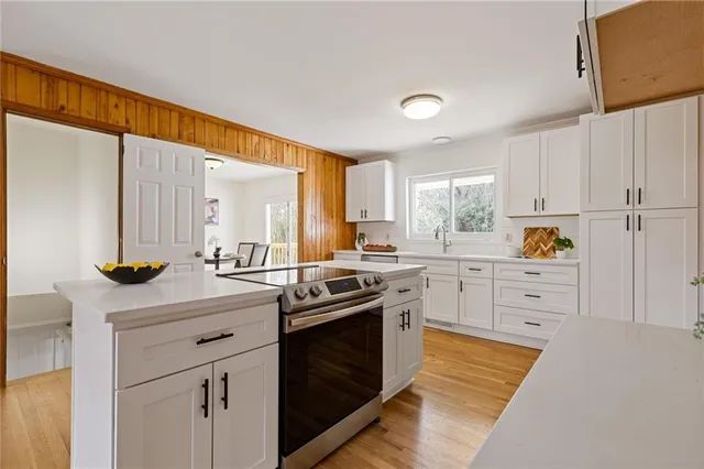 a open kitchen with stainless steel appliances granite countertop a stove and a refrigerator