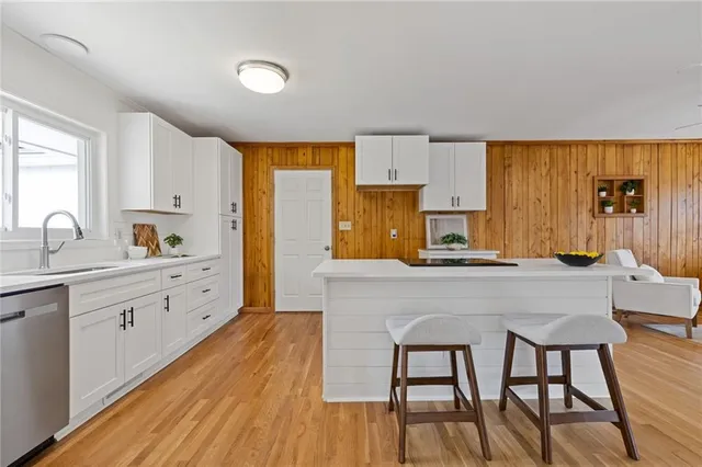 a bathroom with a granite countertop toilet sink and mirror