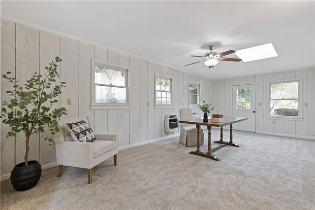 a bathroom with a granite countertop toilet a sink and mirror