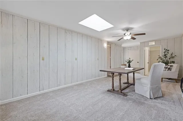 a bedroom with bed mirror and window
