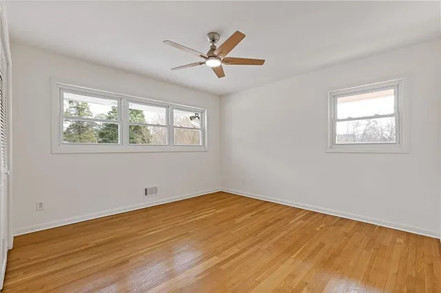 a view of an empty room with wooden floor