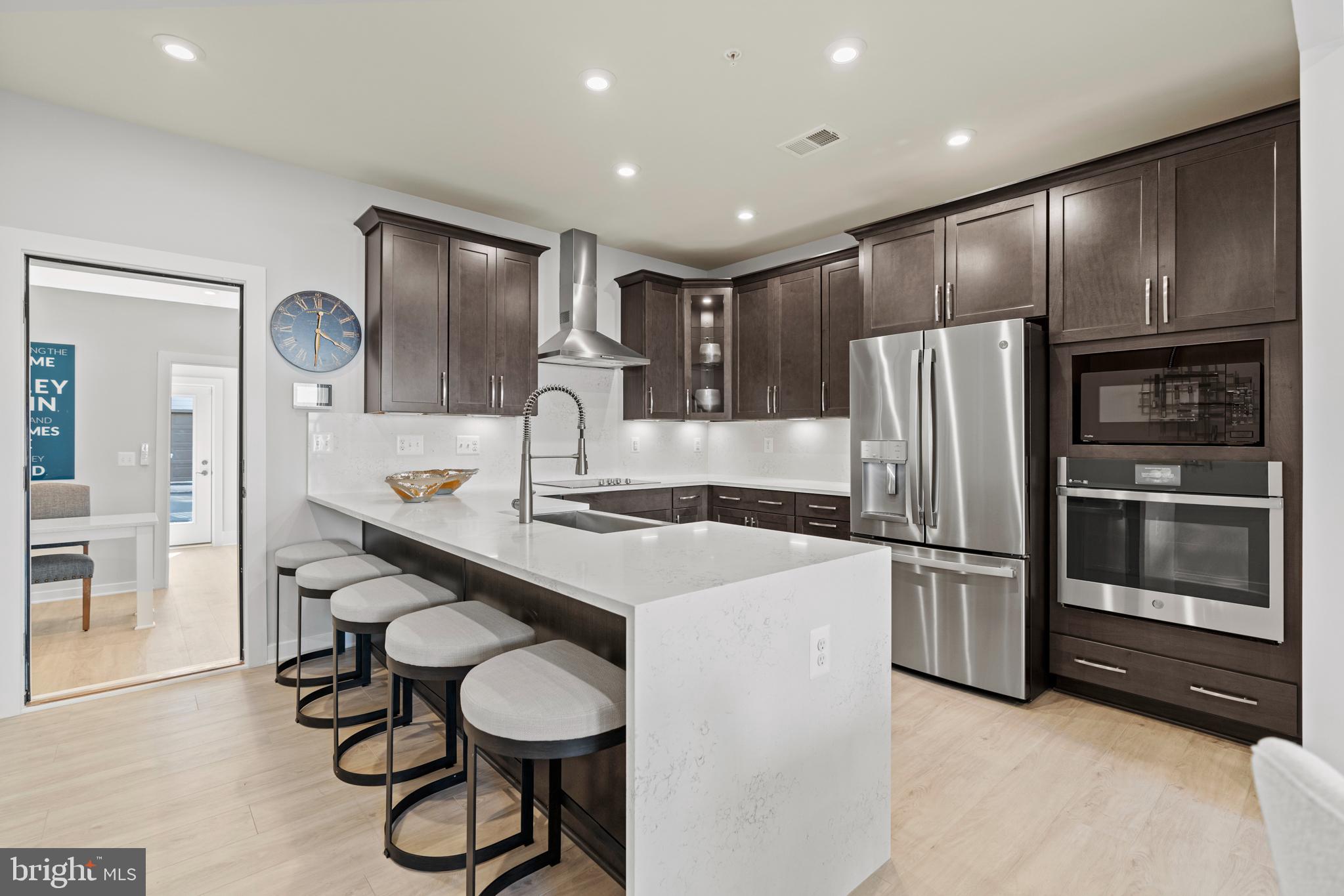 44514 Wolfhound Square Ashburn, VA 20147 - Photo 1 of 30 a kitchen with stainless steel appliances a refrigerator and a stove top oven with wooden floor