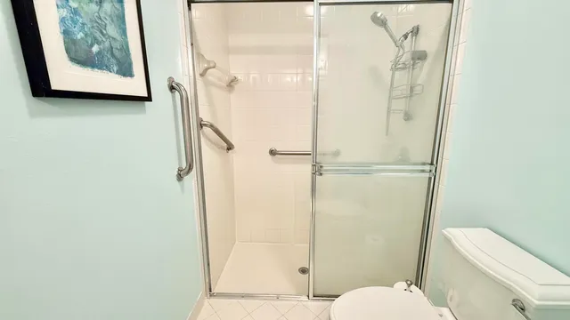 a bathroom with a toilet and a shower
