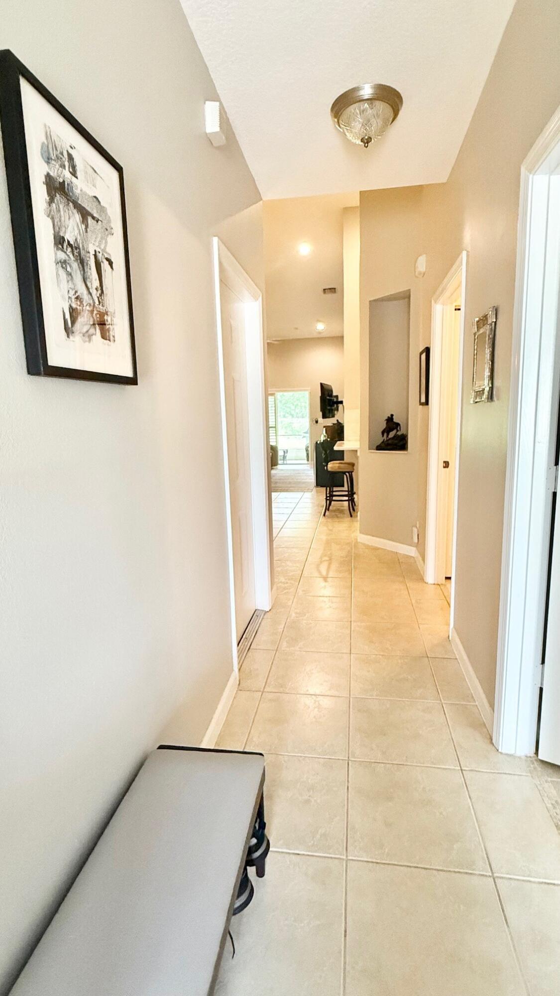 9905 Galleon Drive West Palm Beach, FL 33411 - Photo 2 of 16 a view of a hallway with a dining table and chairs