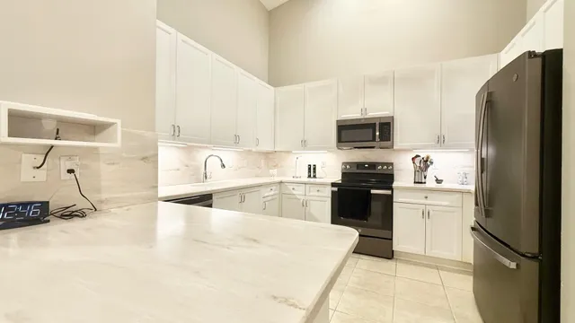 a kitchen with a refrigerator stove and microwave