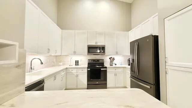 a kitchen with a refrigerator stove and sink