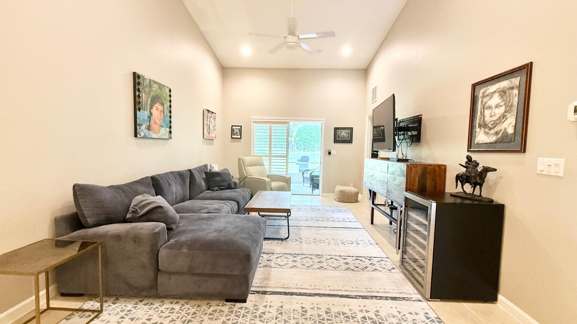 9905 Galleon Drive West Palm Beach, FL 33411 - Photo 6 of 16 a living room with furniture a large window and flat screen tv