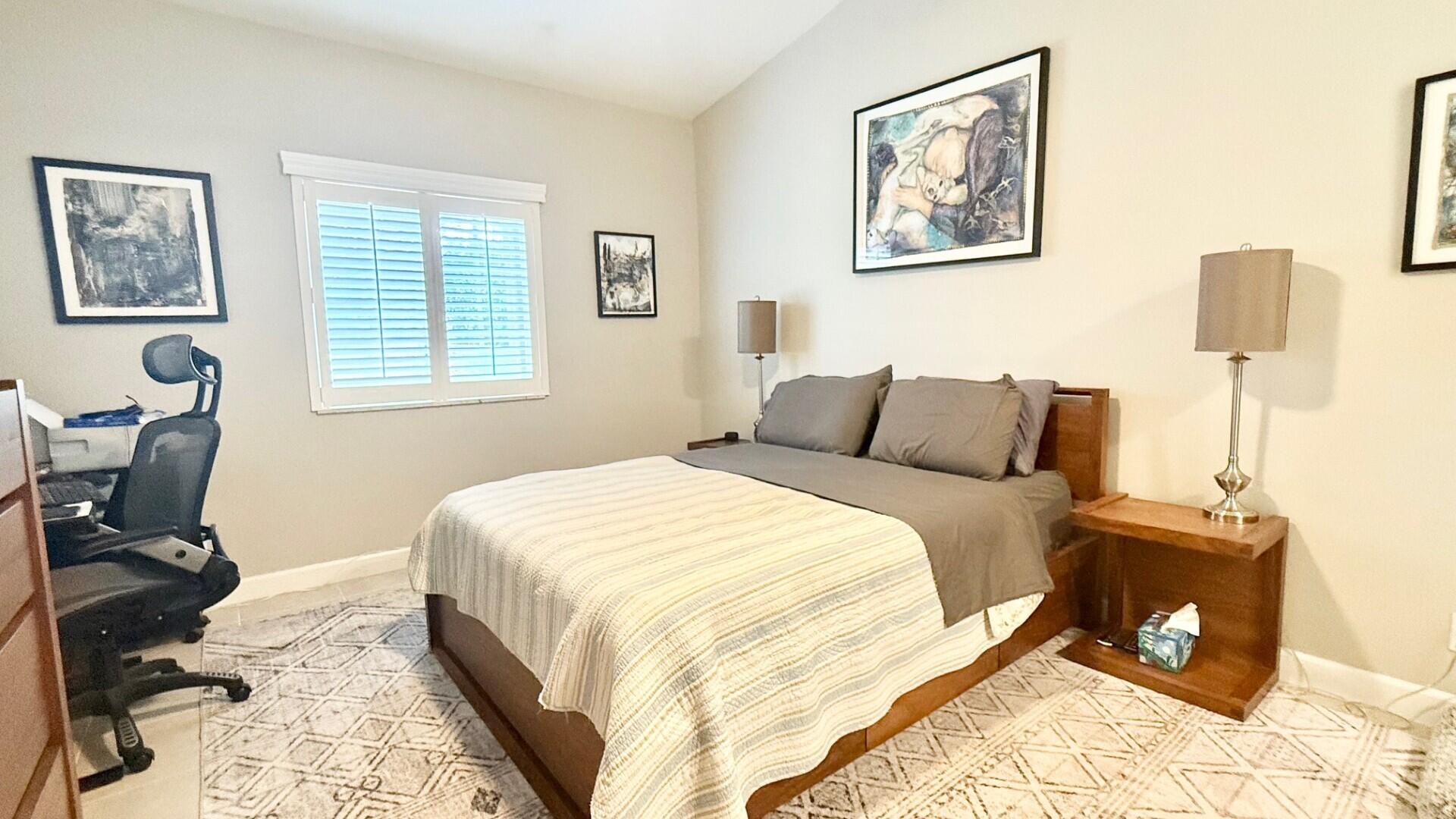 9905 Galleon Drive West Palm Beach, FL 33411 - Photo 9 of 16 a bedroom with a bed and wooden floor