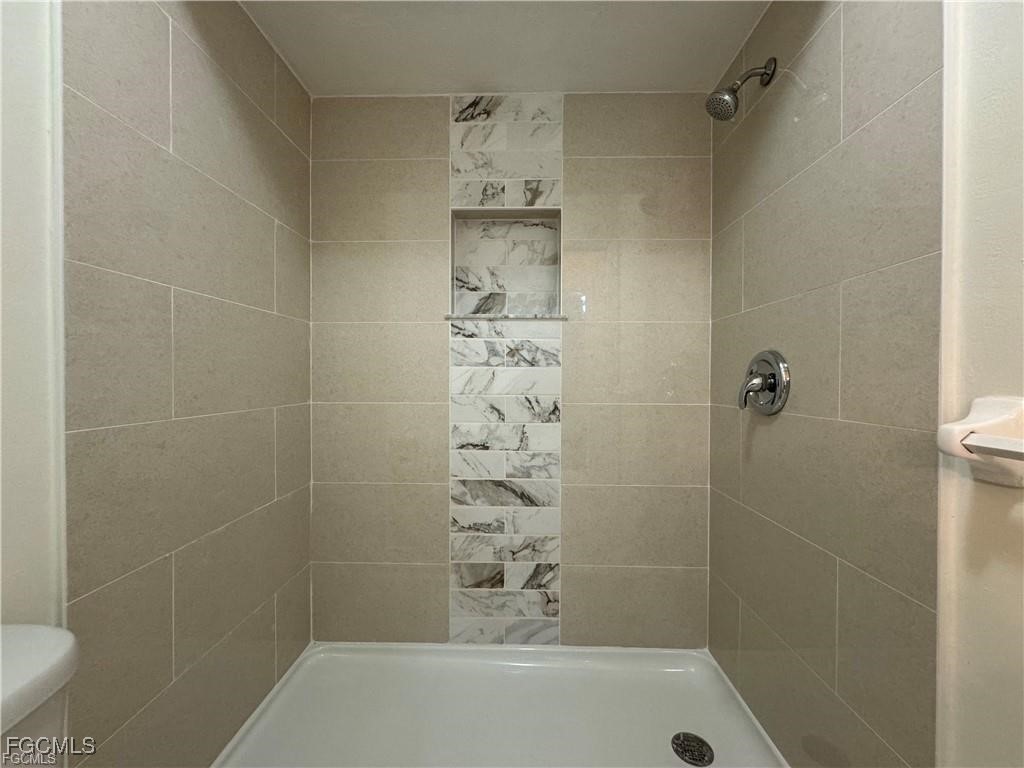 645 Homestead Road South Lehigh Acres, FL 33974 - Photo 12 of 17 a bathroom with a shower