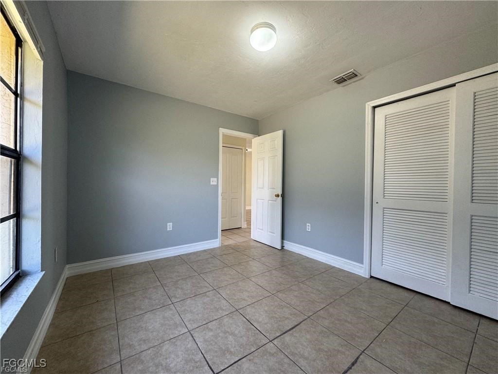 645 Homestead Road South Lehigh Acres, FL 33974 - Photo 15 of 17 an empty room with windows and closet