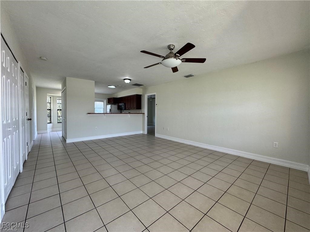 645 Homestead Road South Lehigh Acres, FL 33974 - Photo 2 of 17 a view of an empty room and chandelier fan