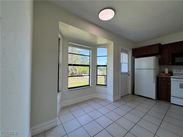 a view of a kitchen with a closet and windows