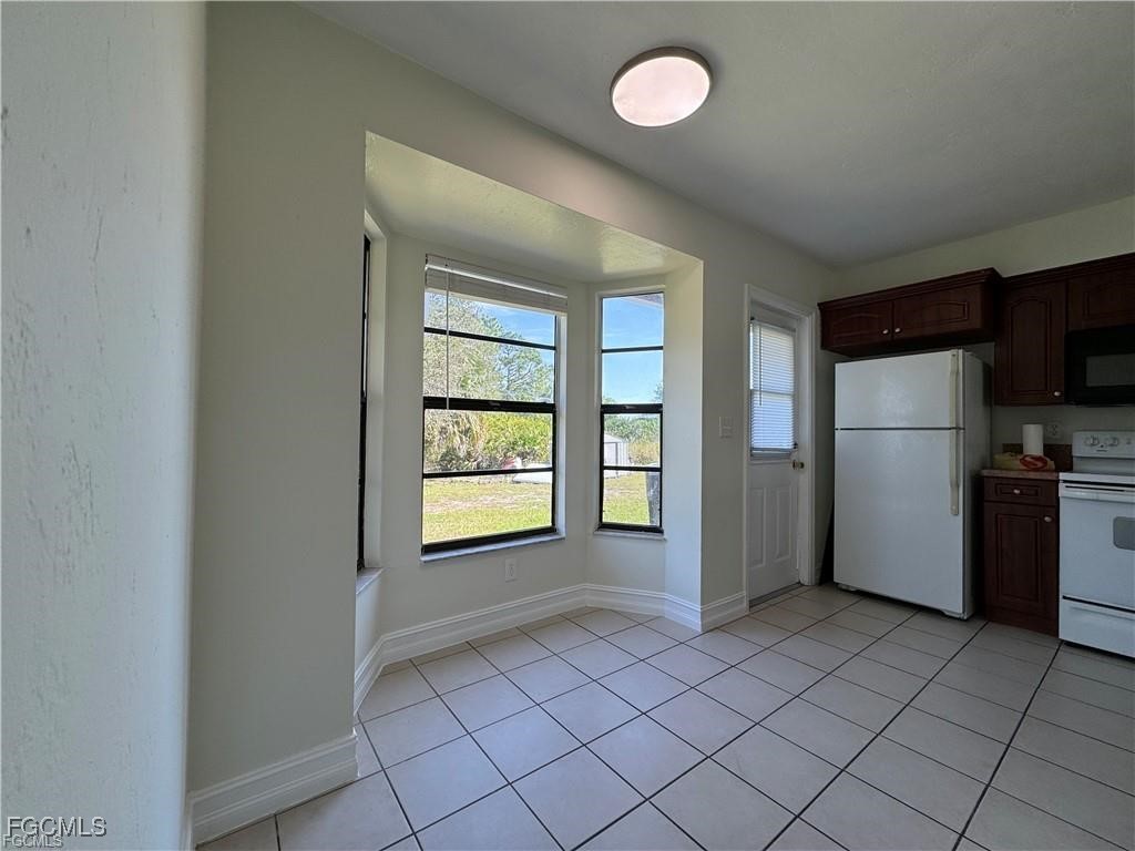 645 Homestead Road South Lehigh Acres, FL 33974 - Photo 4 of 17 a view of a kitchen with a closet and windows