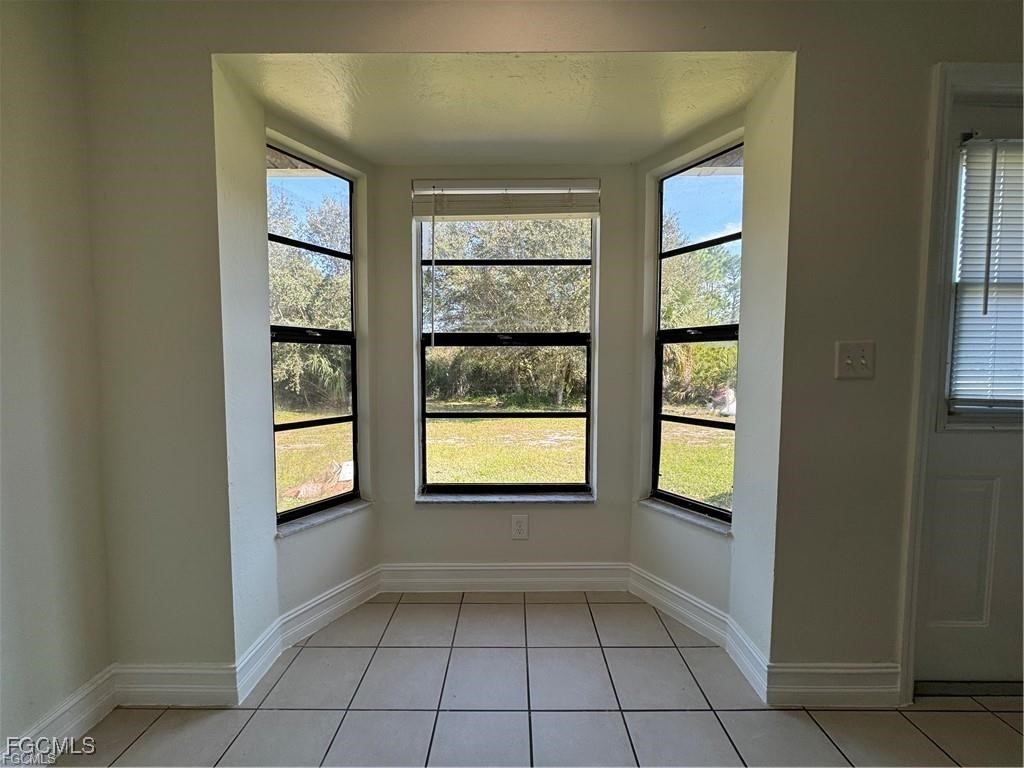 645 Homestead Road South Lehigh Acres, FL 33974 - Photo 5 of 17 an empty room with windows and closet