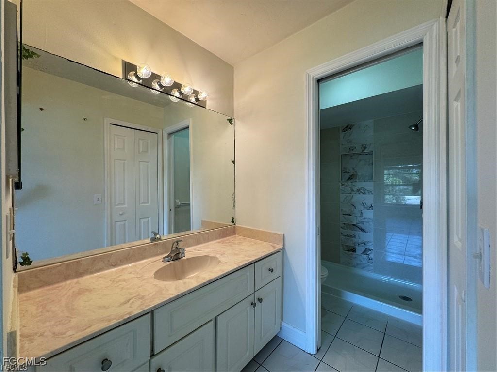 645 Homestead Road South Lehigh Acres, FL 33974 - Photo 10 of 17 a bathroom with a sink and a mirror
