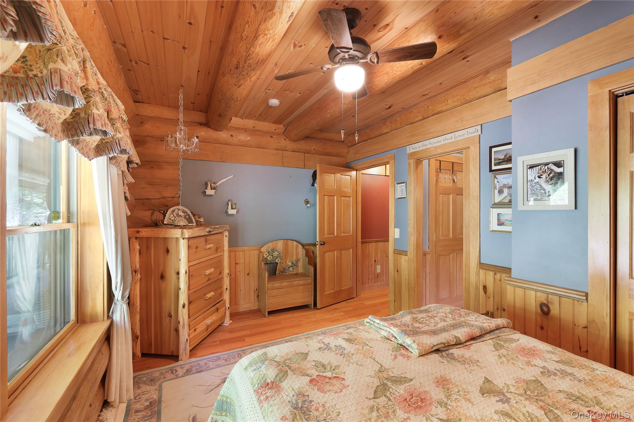 25 Cauthers Road Fallsburg, NY 12789 - Photo 17 of 27 a bedroom with a bed and a chandelier