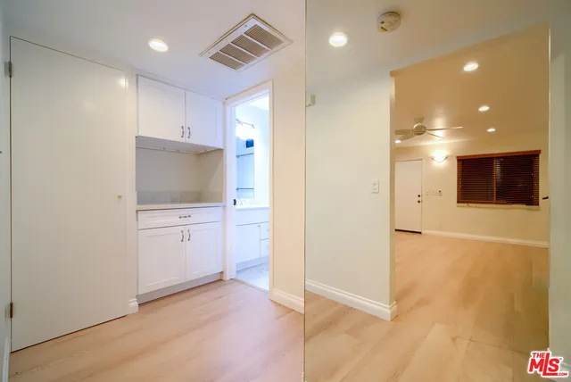 a bedroom with a bed and a potted plant